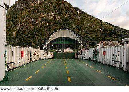 Ferry Leaving Eidsdal Ferry Port Whit A Man Standing And Looking On A Fall Evening