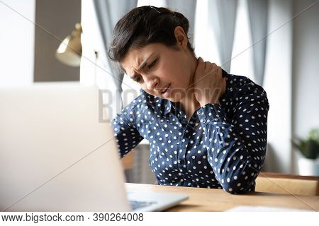 Indian Woman Sitting At Desk Touch Neck Feels Pain
