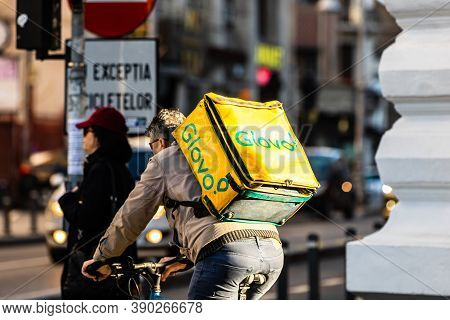A Glovo Food Delivery Courier On A Bike. Restaurants Are Closed And Only Deliveries Are Allowed Duri