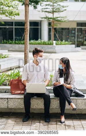 Multi-ethnic Unversity Students In Medical Masks Spending Time On Campus And Working On Project