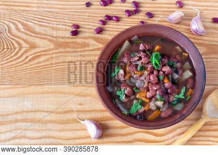 Bean Soup With Cilantro In Clay Plate On Wooden Background. Rustic Style. Top View, Copy Space