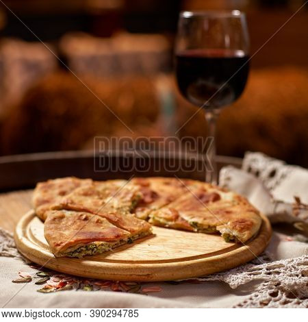 Glass Of Red Wine And Pieces Of Placida With Cottage Cheese Or Vertuta On A Wooden Tray, Close-up, T