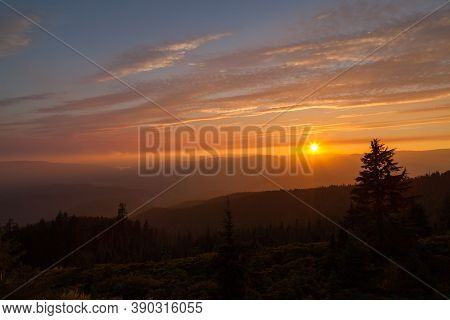 Thick Layers Of Smoke From A Nearby Forest Fire Turn The Suns Rays A Glowing Orange As It Sets Over 