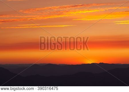 Thick Layers Of Smoke From A Nearby Forest Fire Turn The Suns Rays A Glowing Orange As It Sets Over 