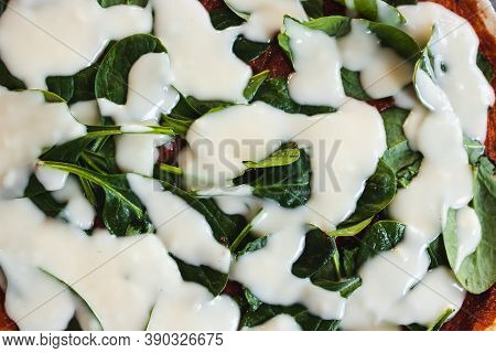 Plant-based Food, Vegan Pizza With Cashew Cheese  And Spinach About To Go In The Oven