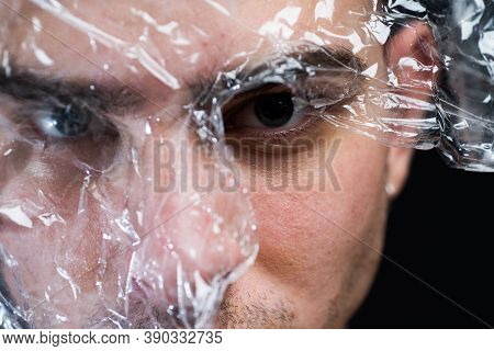 Trash Concept. Plastic Pollution. Man Transparent Piece Of Plastic Surrounded His Head. Health Care.