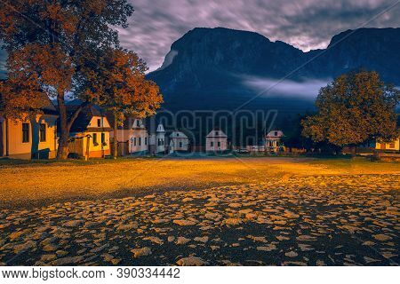 Beautiful Rural Street With Traditional Houses In Row At Dawn. Torocko Village And Stunning Piatra S