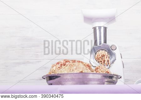 Electric White Meat Grinder. Minced Meat Is Wound And Lies In A Metal Bowl. Copy Space. Text.