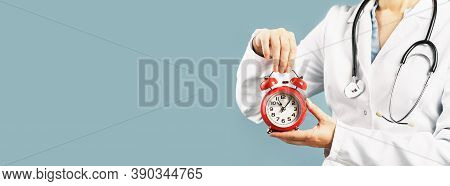 Doctors Hands Holding Red Alarm Clock Over Blue Background. Time Is Crucial Life Saver. Medical Bann
