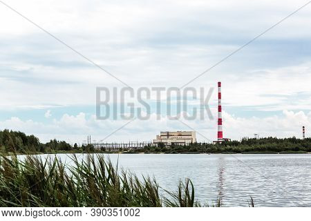 Combined Heat And Power Plant And A Lake With Cooling Fountains. Chp For The Production And Supply O