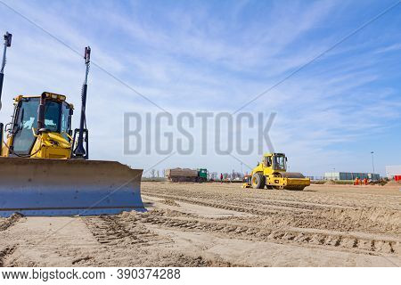 Vibration Plate Compactor Is Mounted To The Steamroller, Compacting Sand At Road Construction Site.