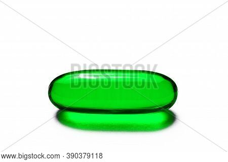 Green Single Capsule Isolated On White. Medicine Healthcare Background. Drugs Dose In Group. Painkil
