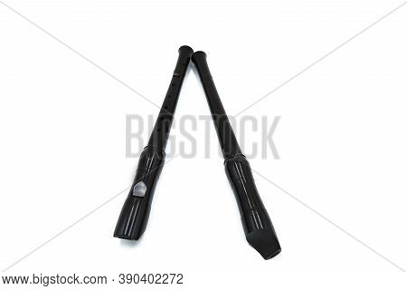 Two Black Flute Recorder On A White Isolated Background, Close Up, Textured