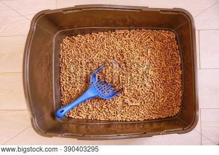 Brown Toilet Tray For Cat With Wood Pellets And Scoop. The Cats Toilet Clean Is Filled With Granules
