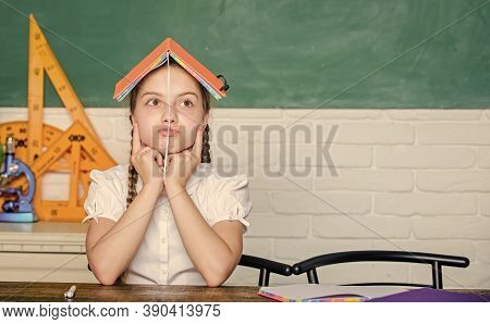 Girl Cute Child Sit School Classroom Chalkboard Background. Small Kid Study School. Progress And Ach