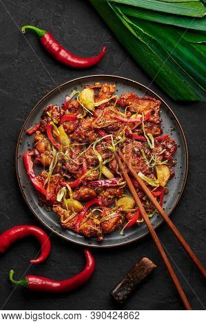 Kkanpunggi Or Korean Spicy Garlic Fried Chicken On Black Plate On Dark Slate Table Top. Kan Pung Gi