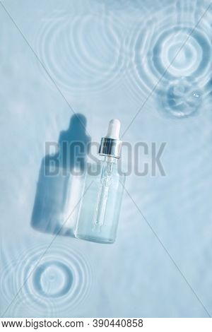 Cosmetic Spa Medical Skin Care, Bottle For Serum, Micellar Toner And Emulsion On Water Texture Backg