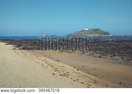 Yellow Sand Beach And White Lighthouse On The Island In The Background On A Sunny Summer Day. Island