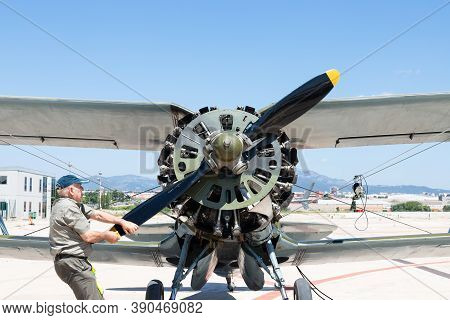 Sabadell, Spain - 16 June 2019 : Elder Man Manually Starting The Engine Of An Old Airplane At The Sa