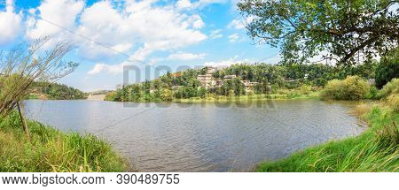 The idyllic mountain tranditional village by river on a beautiful summer afteroon with blossoming trees and grasses in the south of China. Panorama shots by six photos.