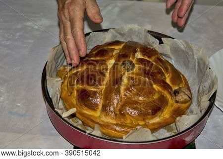 The Hands Of An Elderly Housewife Who Baked A Celebration Cake - Bread For The Upcoming Celebrations