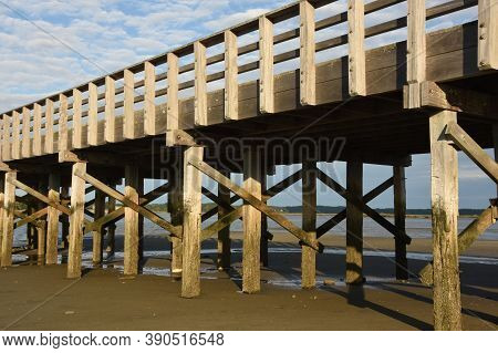 Looking At A Wooden Bridge Over A Bay In Duxbury.