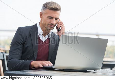 Communicating To World. Employee Talk On Phone Working On Laptop. Business Communication. Using Comp
