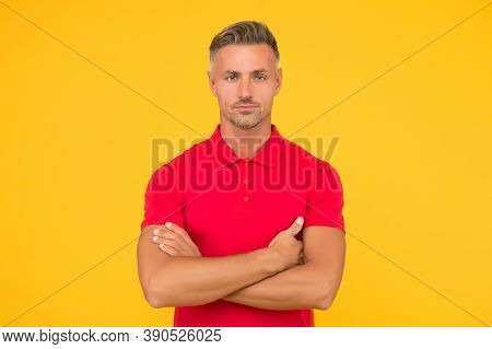 Handsome Caucasian Guy With Unshaven Face Hair Wear Red Thirt Keeping Arms Crossed Yellow Background