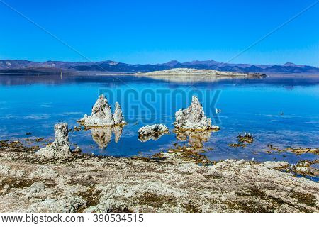 Mono Lake is a natural wonder of the world. Picturesque lake with lime-tuff towers of fancy shape. Evening by the lake. The concept of active, ecological, exotic and photo tourism