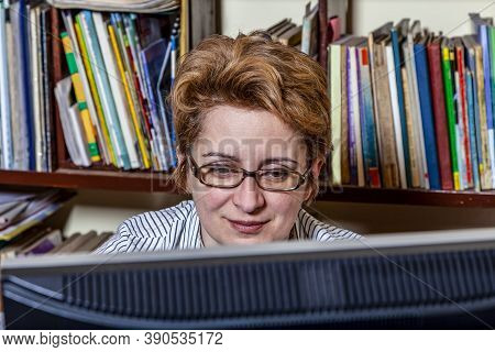 Portrait Of A Busy Woman Teleworking At Her Desk At The Home. Working At Home Became An Important Re