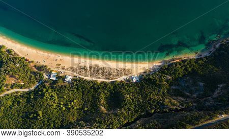 Aerial View Of Blue Atlantic Ocean, Green Forest Mountains And Sandy Praia Do Portinho Da Arrabida B
