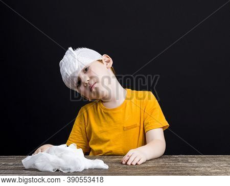 A Beautiful Boy With Red Hair With A Damaged Head Bandages Himself With A Medical Bandage, A Boy Wit