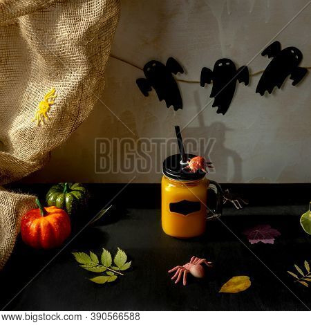 Orange Halloween Mococktail And Holiday Decor On A Dark Mystical Autumn Background. Chosts On Backgr