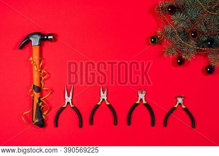 Construction Inturments Hammer, Pliers, Cutters, Round-cutters And Tongs With A Christmas Fir Branch