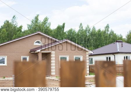 Wooden Fence On The Background Of The Cottage. View From The Window Of A House In The Village. Movin