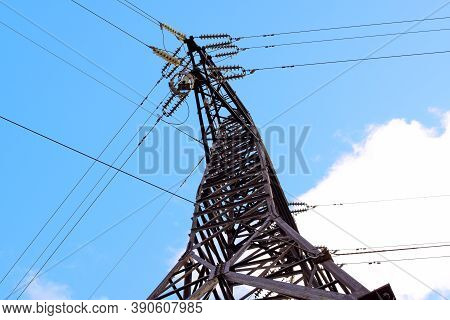 Power Transmission Tower Against The Sky. Bottom View. Electricity For Transmission Of Power Through