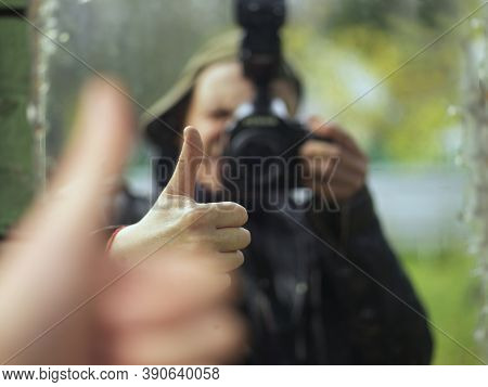 Reflection Of A Photographer In A Mirror Gesturing Okay Sign While Shooting, Shallow Dof