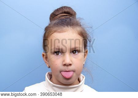A Girl Preschooler Makes A Tongue In Cheek Exercise. For The Correct Pronunciation Of Letters