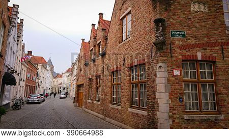 Bruges, Belgium - May 12, 2018:  Roofs And Windows Of Old Authentic Brick Houses On Street Ontvanger