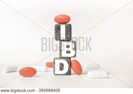 A Group Of White And Red Pills And Cubes With The Word Ibd Inflammatory Bowel Disease On Them, White