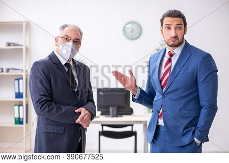 Two employees at workplace during pandemic