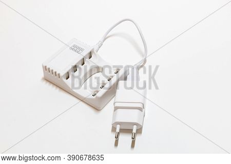 White Charger For Batteries On A White Background