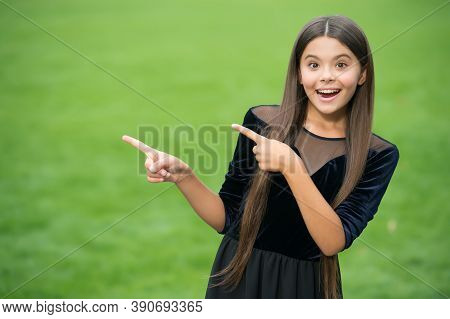 Look At This. Happy Girl Point Index Fingers Green Grass. Objective Pointing. Hand Gesture. Marketin