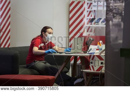 Belgrade, Serbia - October 5, 2020: Young Woman Staff Worker Of A Phone Carrier Shop Wearing A Respi