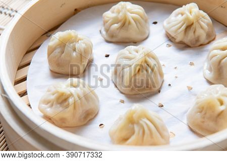 Steamed Xiaolongbao Served In A Traditional Steaming Basket (.close Up)