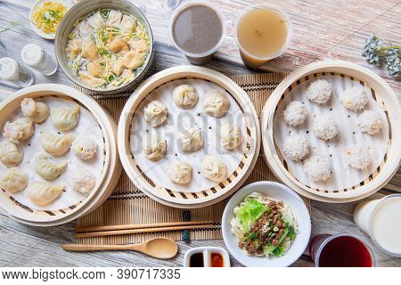 Steamed Xiaolongbao And Steamed Dumplings Served In A Traditional Steaming Basket