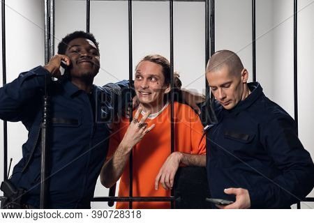 Warders In A High-security Prison Mock A Prisoner In A Cell, Take Photos With Him On A Smartphone