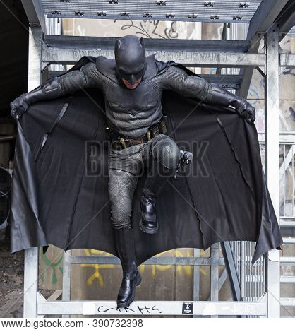Umea, Norrland Sweden - September 5, 2020: Cosplayers Dressed As Batman Jump From Stairs