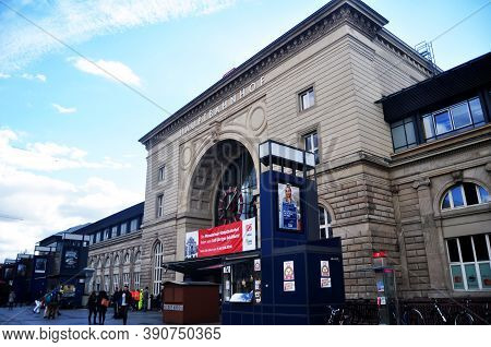 German People And Foreign Travelers Walking In And Out Of Building Go To Train At Platform Of Mannhe