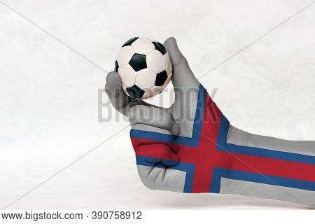 Mini Ball Of Football In Faroe Islands Flag Painted Hand, Hold It With Two Finger On White Backgroun